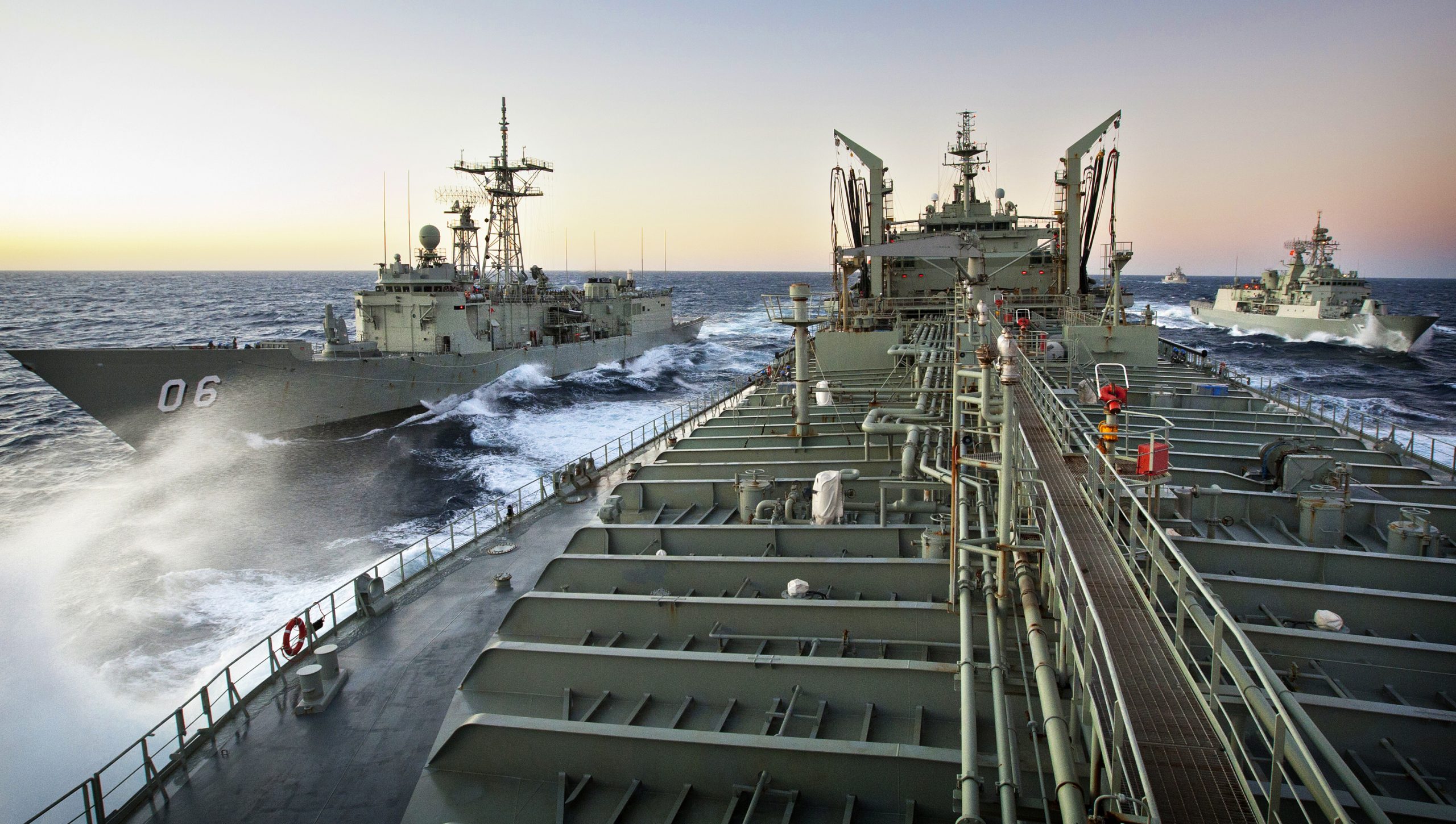 HMA Ships Newcastle and Warramunga pull up to station's 1 and 2 for a replenishment at sea from HMAS Sirius, HMNZS Te Kaha takes up lifeguard station to the rear of the evolution. Mid Caption: The Royal Australian Navy has conducted a major exercise off the coast of Western Australia. Exercise Triton Storm is conducted annually to ensure ships and personnel are appropriately trained for the year ahead. The exercise also helps new personnel integrate into the participating ship's company and to test the skills in a practical situation.